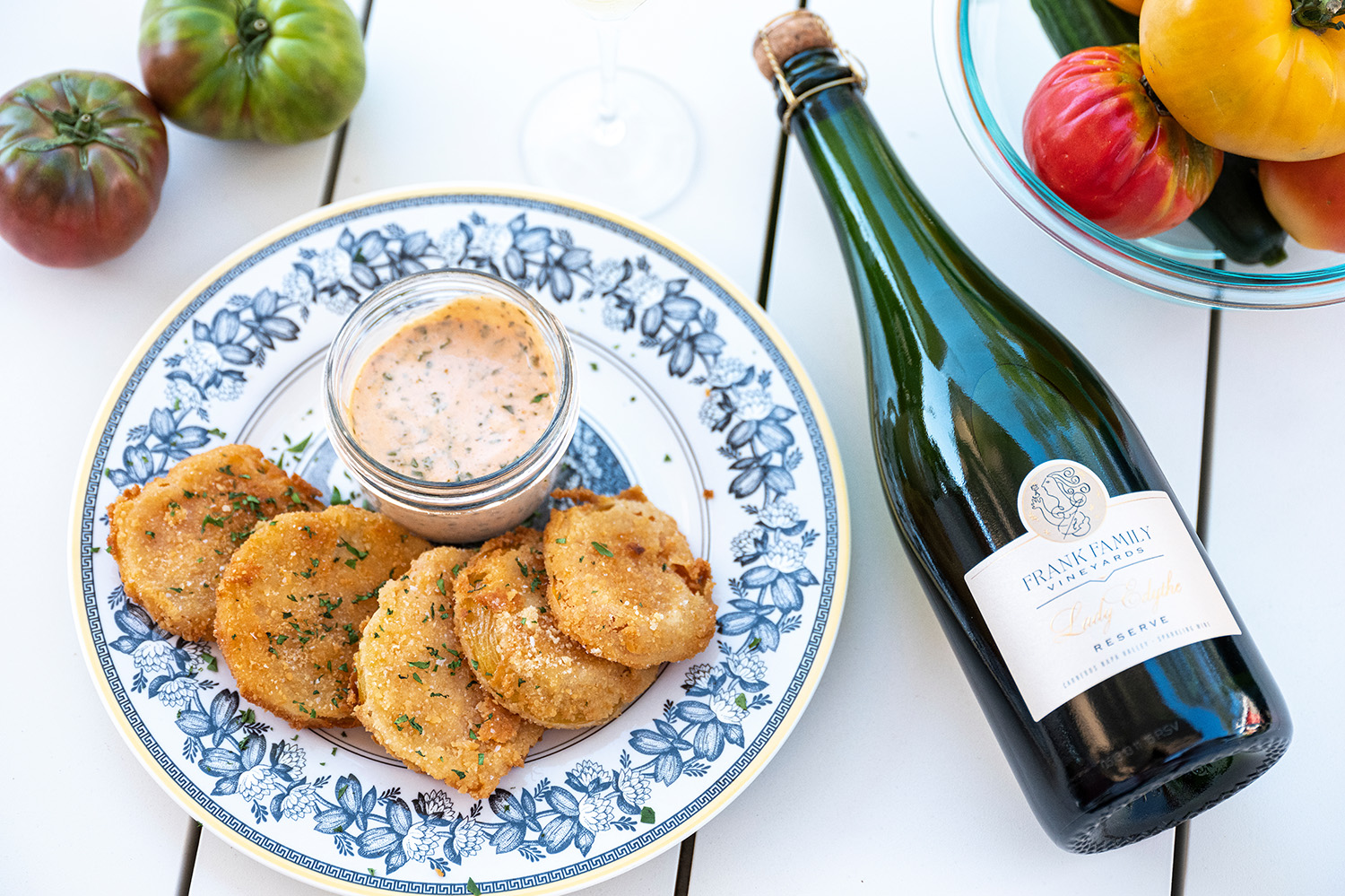 Fried green tomatoes next to a bottle of Frank Family's Lady Edythe Reserve Brut