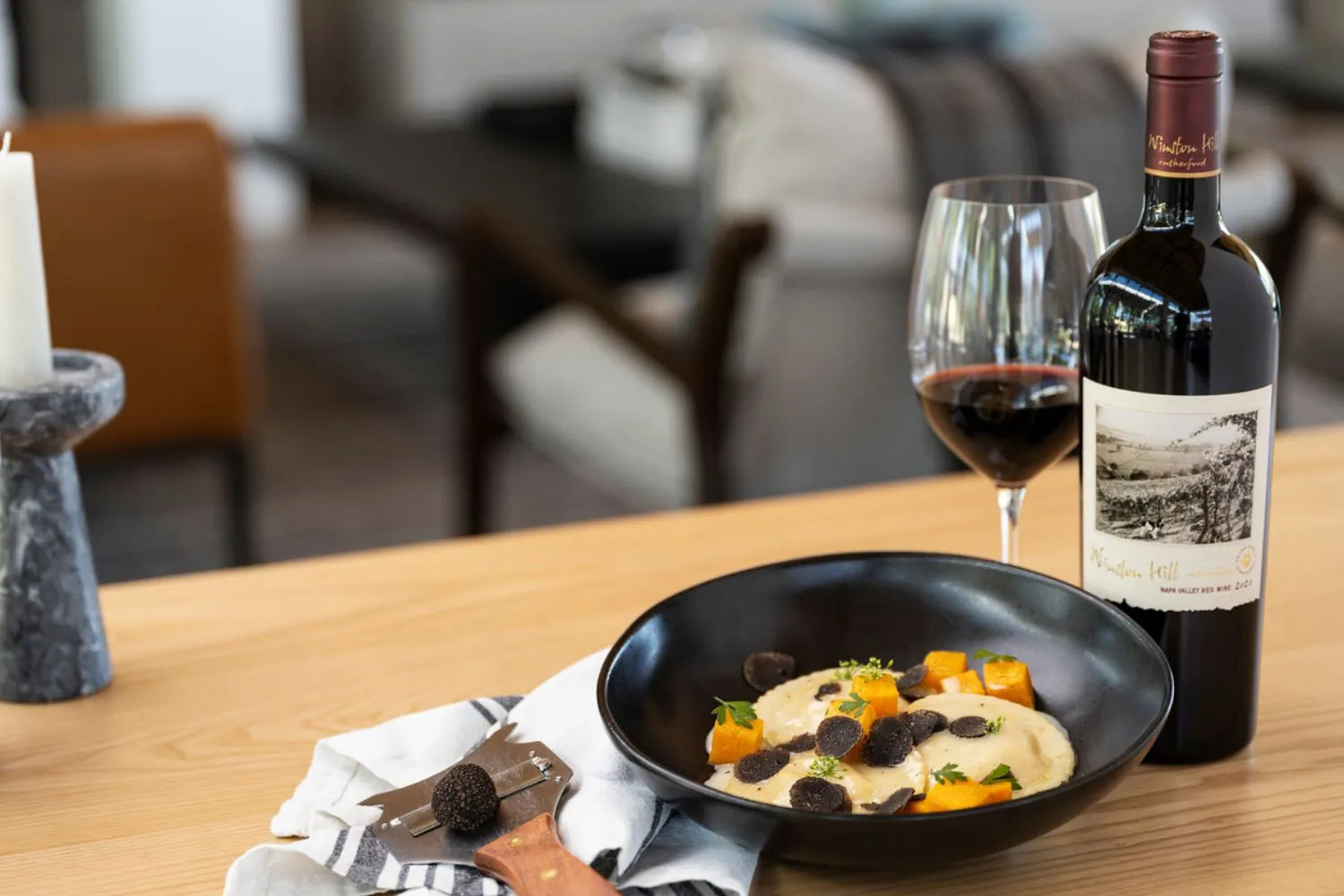 A dish of Pumpkin Raviolo served alongside a glass of Frank Family's Winston Hill Cabernet.
